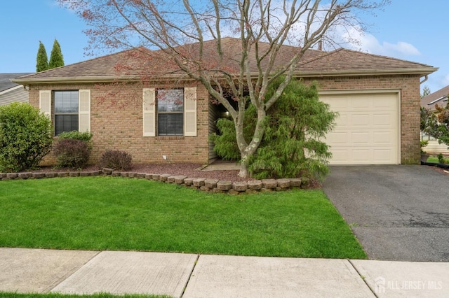 single story home featuring a front lawn, brick siding, a shingled roof, an attached garage, and driveway