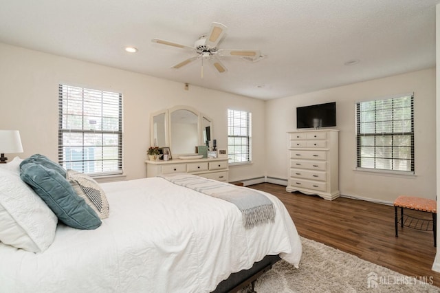 bedroom with dark wood-style flooring, a ceiling fan, baseboards, recessed lighting, and a baseboard heating unit