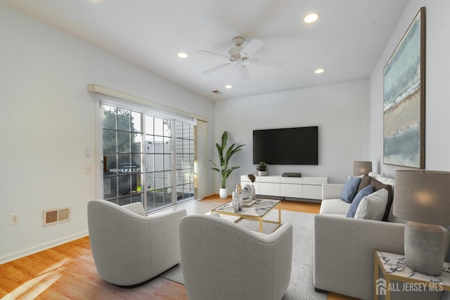 living area featuring visible vents, recessed lighting, baseboards, and wood finished floors