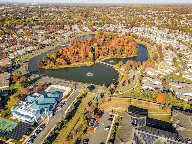 drone / aerial view with a water view and a residential view