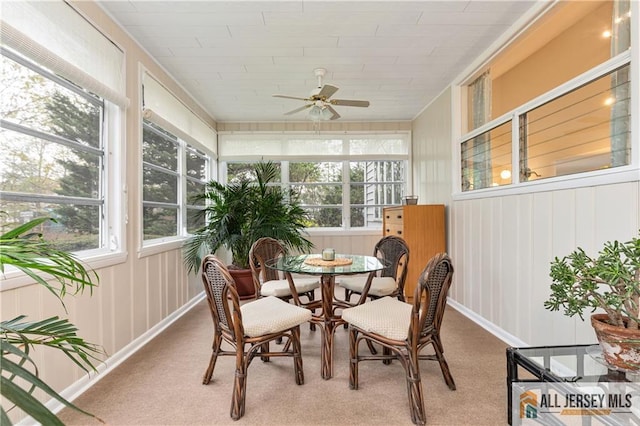 sunroom / solarium featuring outdoor dining space and ceiling fan