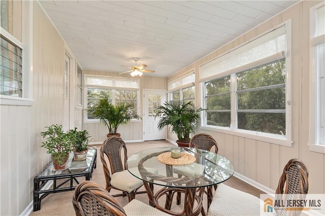 sunroom with baseboards and a decorative wall