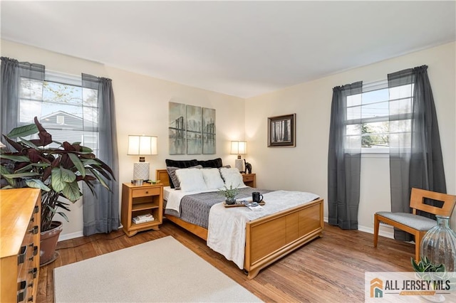 bedroom featuring baseboards and wood finished floors