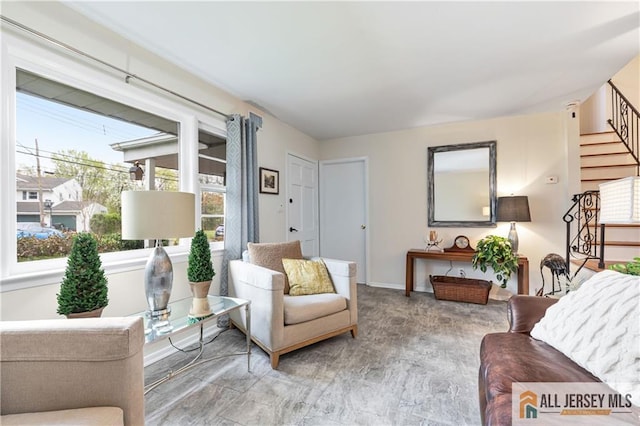 living area with baseboards and stairs