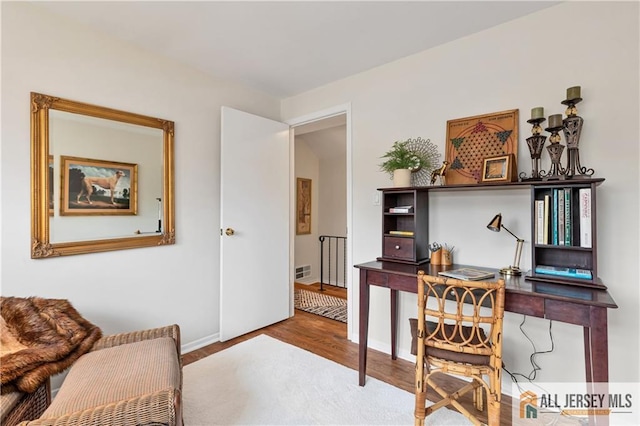 office area featuring baseboards and wood finished floors