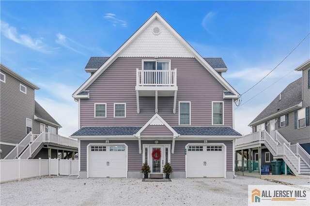 view of front of house with a garage and a balcony