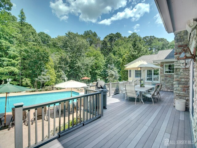 7 Willis Ct, East Brunswick, NJ 08816 - wooden deck featuring outdoor dining space, an outdoor pool, and a view of trees