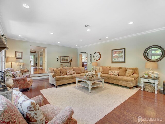 7 Willis Ct, East Brunswick, NJ 08816 - living area featuring wood finished floors, ornamental molding, and recessed lighting
