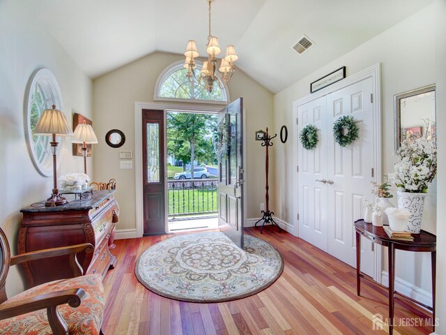 7 Willis Ct, East Brunswick, NJ 08816 - foyer entrance featuring a chandelier, wood finished floors, and vaulted ceiling