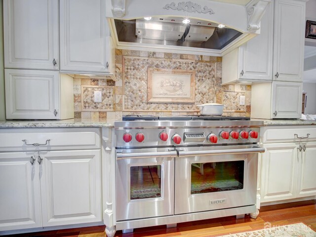 7 Willis Ct, East Brunswick, NJ 08816 - kitchen with double oven range, exhaust hood, white cabinetry, backsplash, and light stone counters