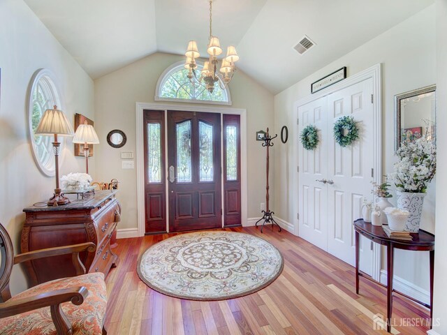 7 Willis Ct, East Brunswick, NJ 08816 - foyer entrance with a chandelier, wood finished floors, and vaulted ceiling