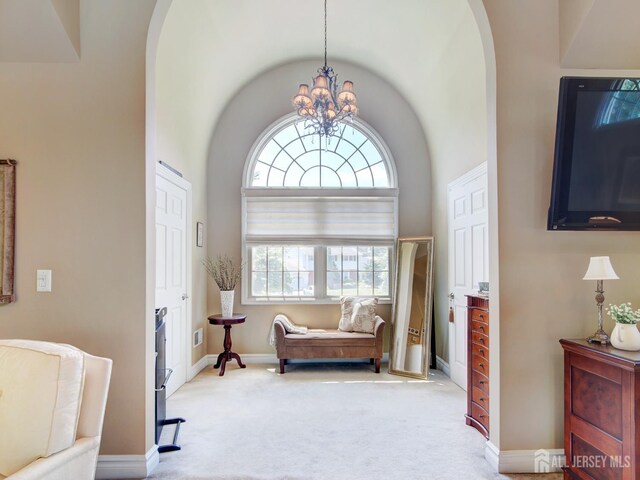 7 Willis Ct, East Brunswick, NJ 08816 - sitting room featuring arched walkways, carpet, a chandelier, and vaulted ceiling
