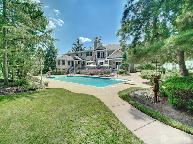 7 Willis Ct, East Brunswick, NJ 08816 - outdoor pool featuring stairs, a lawn, a diving board, and a patio area