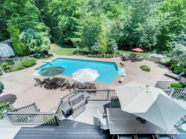 7 Willis Ct, East Brunswick, NJ 08816 - swimming pool featuring outdoor dining area, a shed, a patio, grilling area, and a deck