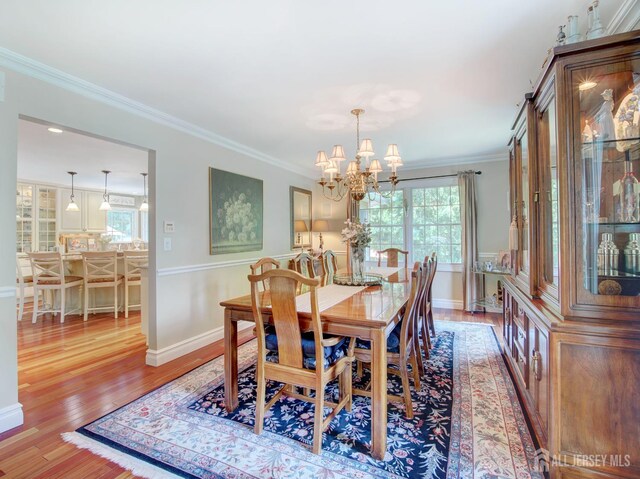 7 Willis Ct, East Brunswick, NJ 08816 - dining room with a chandelier, wood finished floors, and crown molding