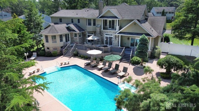 7 Willis Ct, East Brunswick, NJ 08816 - rear view of house featuring stairs, a wooden deck, a patio area, and stone siding