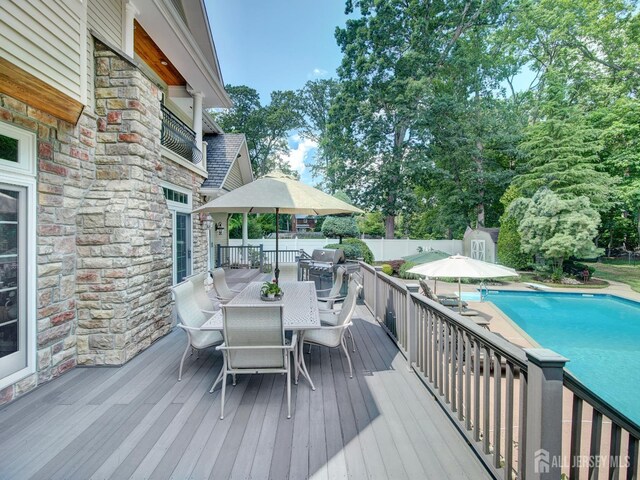 7 Willis Ct, East Brunswick, NJ 08816 - wooden terrace featuring outdoor dining space, a storage shed, a fenced backyard, and area for grilling