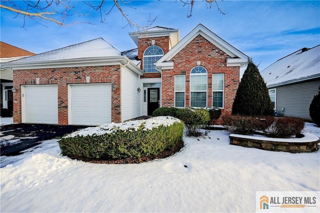 traditional home with brick siding, driveway, and a garage