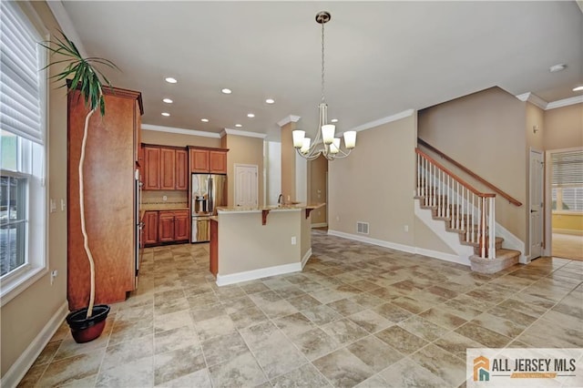 kitchen with visible vents, stainless steel fridge with ice dispenser, a breakfast bar, brown cabinetry, and a notable chandelier