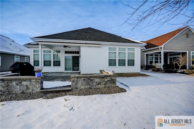 snow covered house featuring a patio and a ceiling fan