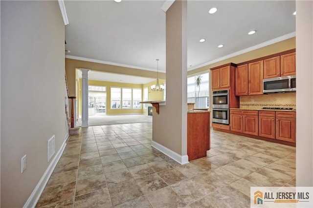 kitchen with decorative backsplash, plenty of natural light, appliances with stainless steel finishes, and decorative columns