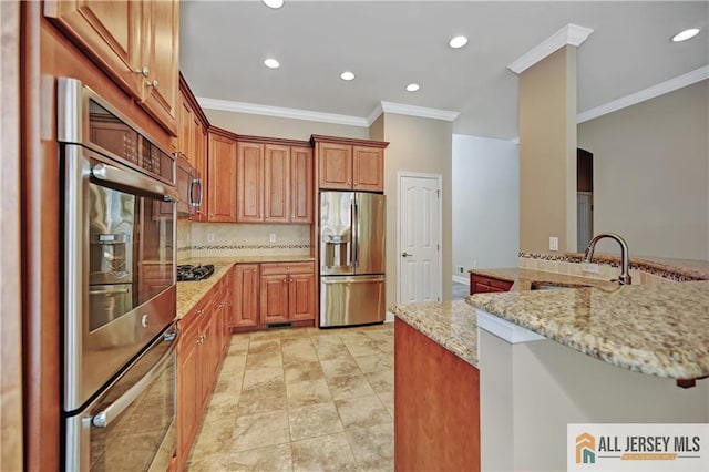 kitchen with ornamental molding, a sink, light stone counters, stainless steel appliances, and decorative backsplash