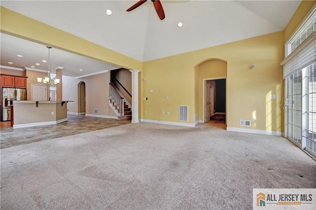 unfurnished living room with visible vents, light colored carpet, and high vaulted ceiling