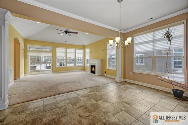 unfurnished living room with visible vents, a lit fireplace, ornamental molding, carpet flooring, and ceiling fan with notable chandelier