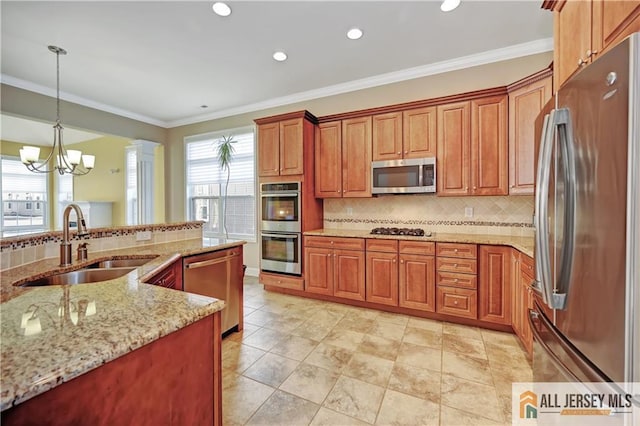 kitchen with a sink, stainless steel appliances, brown cabinets, and crown molding