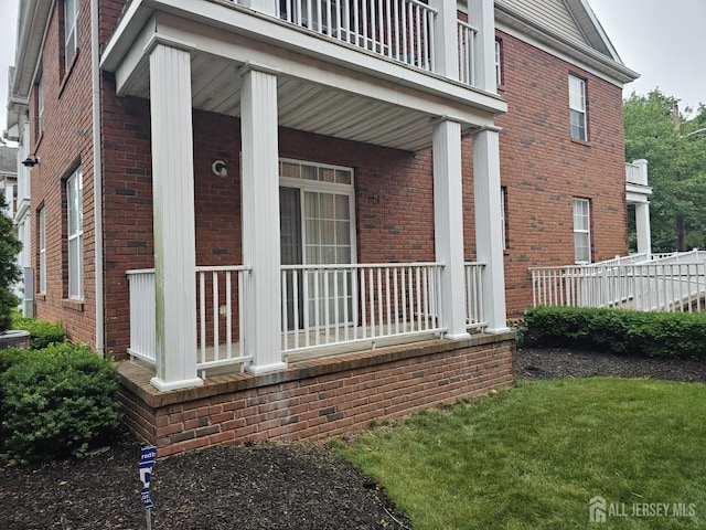 16 Park Sq, Metuchen, NJ 08840 - view of property exterior featuring brick siding, covered porch, and a balcony