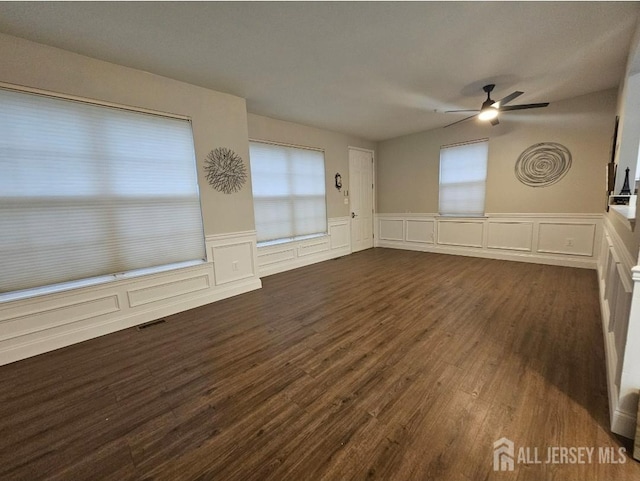 16 Park Sq, Metuchen, NJ 08840 - empty room with ceiling fan, dark wood-style floors, a decorative wall, plenty of natural light, and wainscoting