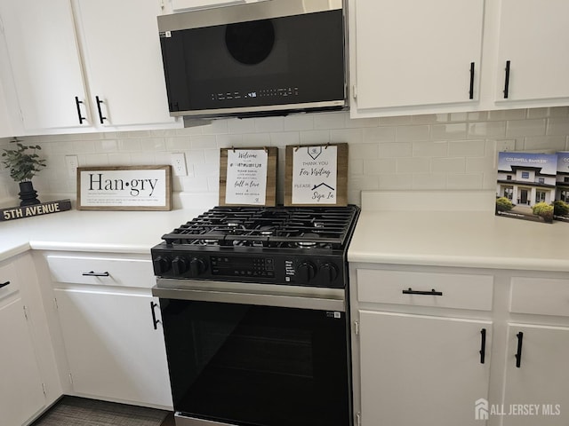 16 Park Sq, Metuchen, NJ 08840 - kitchen with black range with gas cooktop, white cabinetry, light countertops, and backsplash