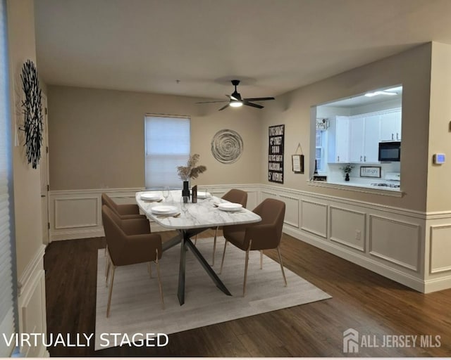 16 Park Sq, Metuchen, NJ 08840 - dining area with a decorative wall, ceiling fan, a wainscoted wall, and dark wood-style flooring