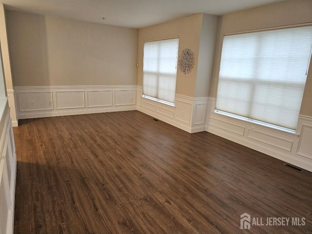 16 Park Sq, Metuchen, NJ 08840 - spare room featuring dark wood-style flooring, wainscoting, and a decorative wall