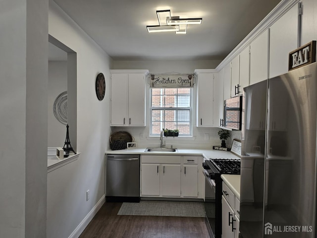 16 Park Sq, Metuchen, NJ 08840 - kitchen featuring stainless steel appliances, dark wood-style flooring, backsplash, white cabinets, and light countertops