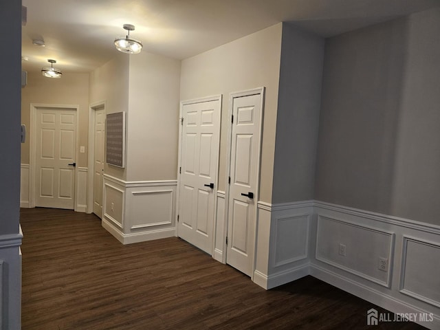 16 Park Sq, Metuchen, NJ 08840 - hall with dark wood-style flooring, a wainscoted wall, and a decorative wall