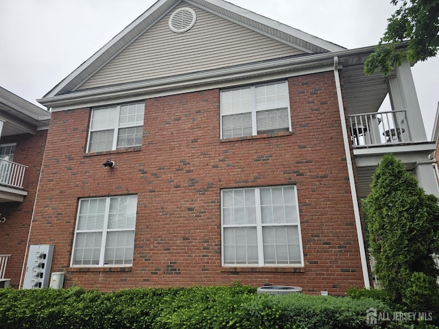 16 Park Sq, Metuchen, NJ 08840 - view of side of home with brick siding and a balcony
