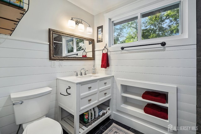 bathroom with tile patterned flooring, vanity, and toilet