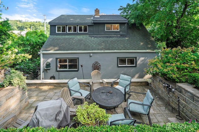 rear view of property featuring a patio area