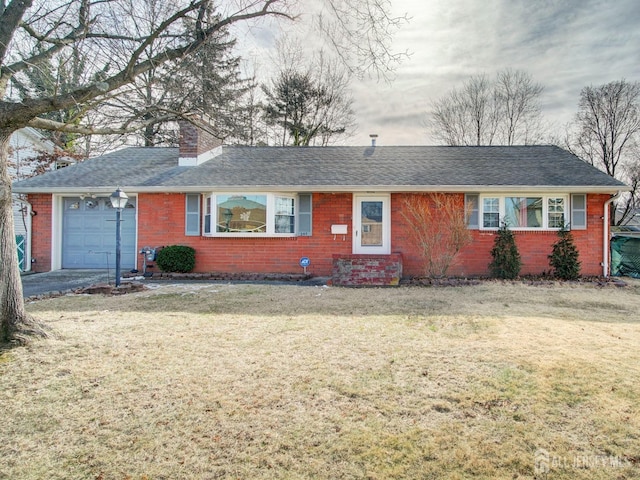 ranch-style home with an attached garage, a front yard, a chimney, and brick siding