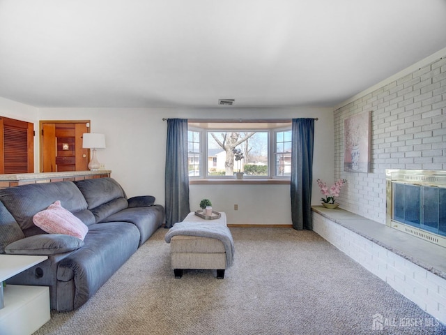 living area featuring visible vents, carpet floors, and a fireplace