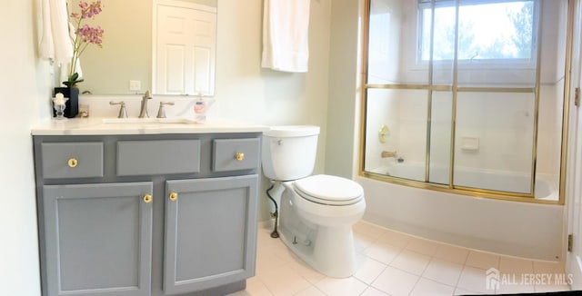 bathroom featuring vanity, toilet, enclosed tub / shower combo, and tile patterned floors