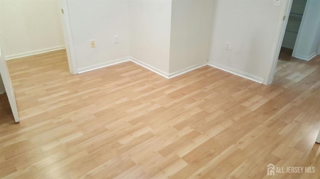 empty room with light hardwood / wood-style floors