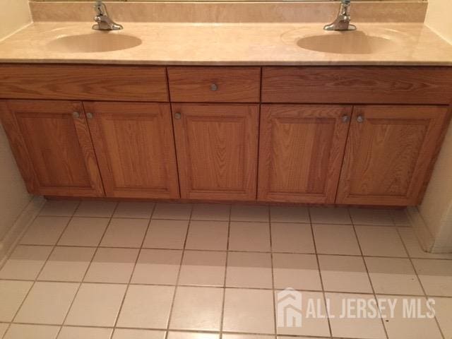 bathroom featuring tile patterned flooring and vanity