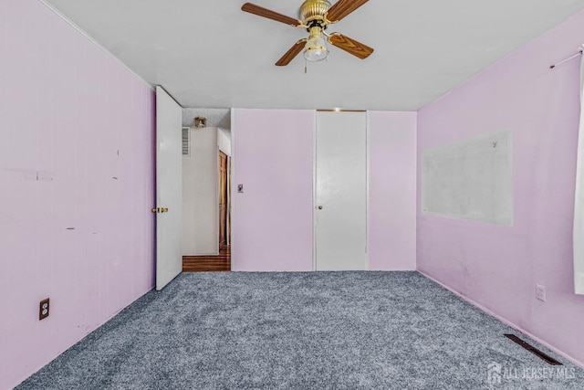 unfurnished bedroom featuring carpet, ceiling fan, and a closet