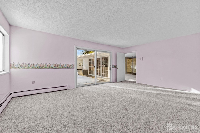 unfurnished room with a textured ceiling, carpet, and a baseboard heating unit