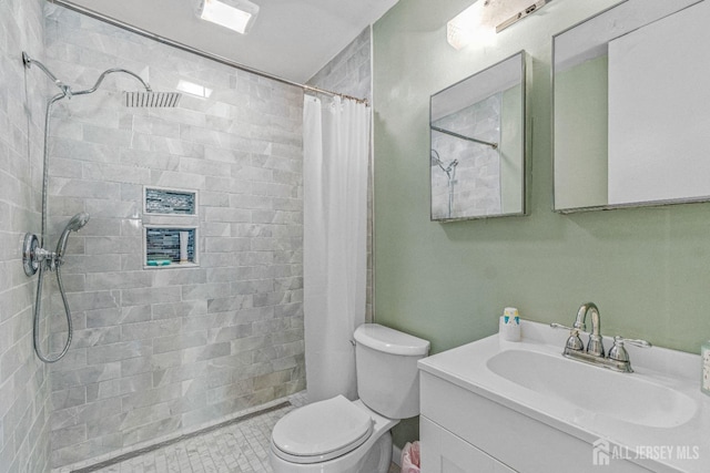 bathroom with walk in shower, vanity, and toilet