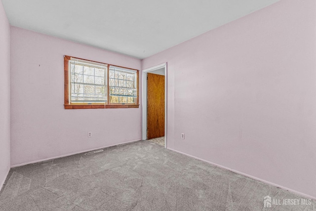 empty room featuring light colored carpet