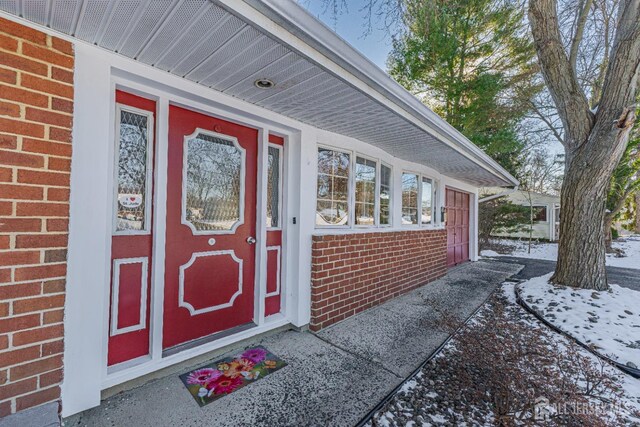 view of snow covered property entrance