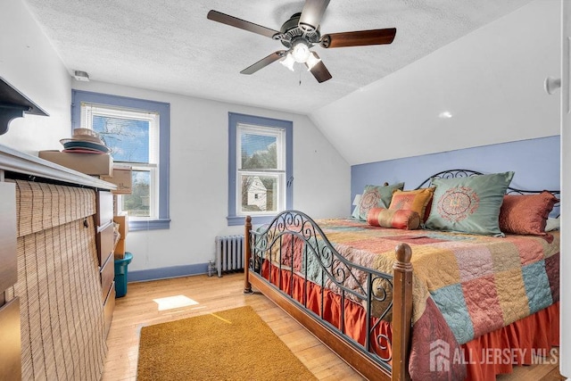 186 Brahma Ave, Bridgewater, NJ 08807 - bedroom with radiator heating unit, a textured ceiling, wood finished floors, ceiling fan, and lofted ceiling